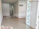 Empty hallway with white walls and a decorative glass door