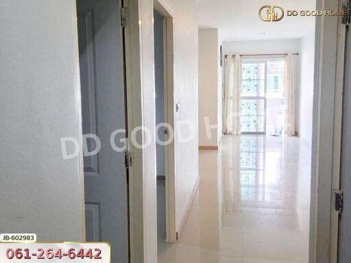 Bright hallway with doors leading to other rooms