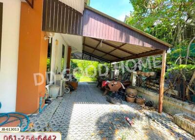 Covered outdoor area with driveway and garden view