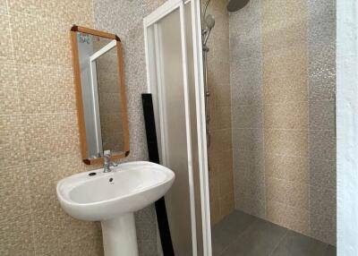 Modern bathroom with a pedestal sink and a walk-in shower