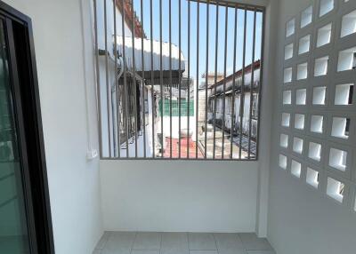 Enclosed balcony with window and grid design