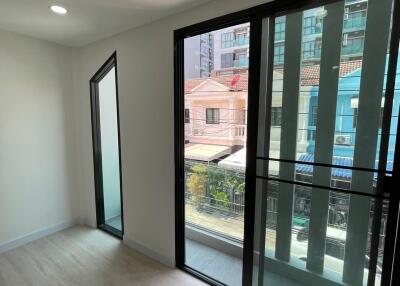 Room with large windows and view of city buildings