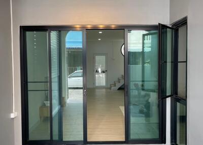 Glass doorway opening to modern interior with stairs