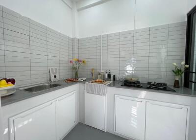 Modern kitchen with countertop appliances and flowers