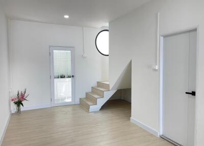 Spacious and modern living room with staircase and natural light