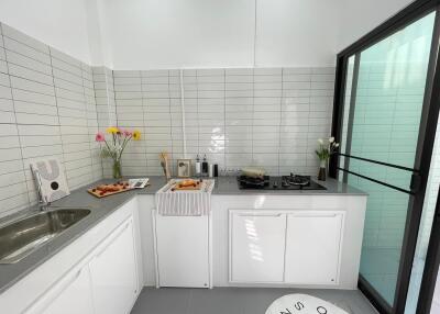 Modern kitchen with sleek countertops and tile backsplash