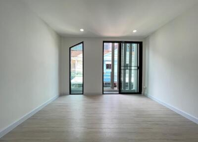 Spacious living room with large windows and ample natural light