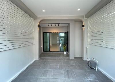 Spacious modern entrance with tiled floor and large windows