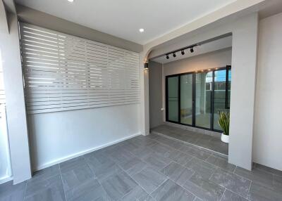 Modern covered porch with large sliding glass doors