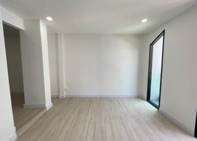 Minimalist living room with wooden flooring and natural light