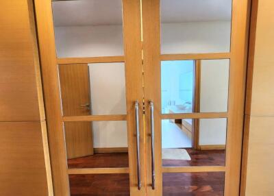 Double wooden doors leading to a bright room