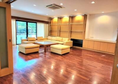 Spacious living room with wooden flooring and large sectional sofa