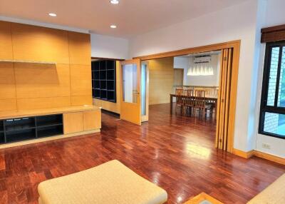 Spacious living area with wooden flooring and dining space