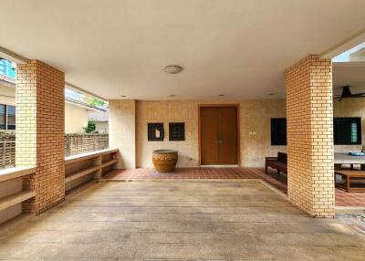 Main entrance and outdoor seating area with brick columns