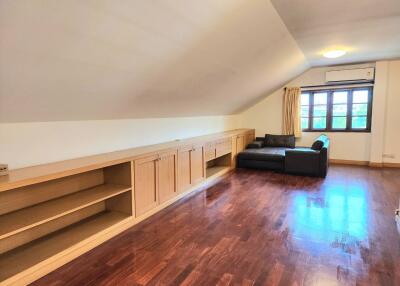 Spacious living room with wooden floors and built-in cabinets
