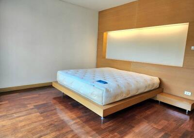 Spacious bedroom with hardwood floor and modern bed