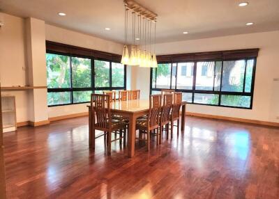 Spacious dining room with wooden floor and modern lighting