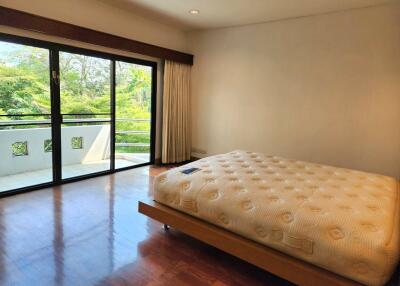 Spacious bedroom with large windows and balcony access