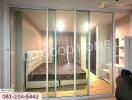 spacious bedroom with bed and glass sliding doors