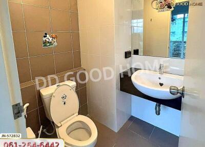 Modern bathroom with tiled walls, toilet, and sink