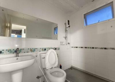 Modern bathroom with shower and tiled wall