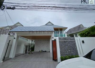 Front view of a modern house with a covered driveway