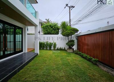 Modern garden view with a patio and well-maintained lawn
