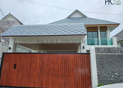 Modern house with wooden gate and stone wall