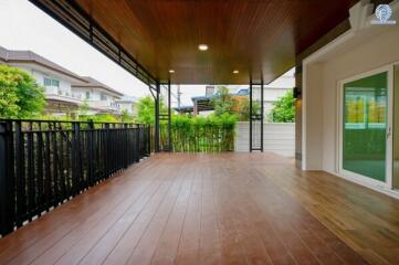 Spacious patio with wooden flooring and ceiling