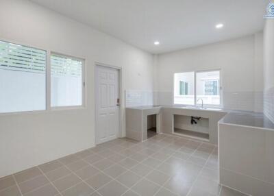 Spacious modern kitchen with large windows and sink