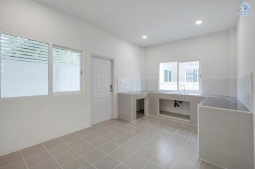 Spacious modern kitchen with large windows and sink