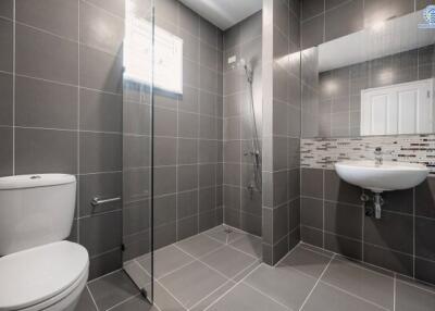 Modern bathroom with grey tiles and walk-in shower