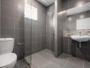 Modern bathroom with grey tiles and walk-in shower