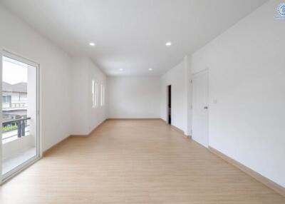 Spacious main living area with wooden floors and ample natural light