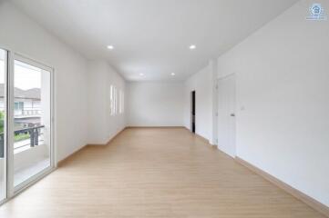 Spacious main living area with wooden floors and ample natural light