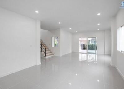 Spacious modern living area with stairs and large windows