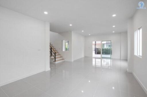 Spacious modern living area with stairs and large windows