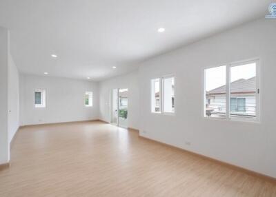 Spacious and bright unfurnished living room with multiple windows