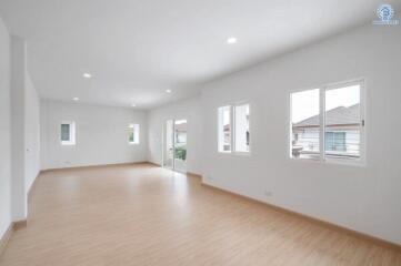 Spacious and bright unfurnished living room with multiple windows