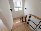 Staircase area with wooden steps and modern railing