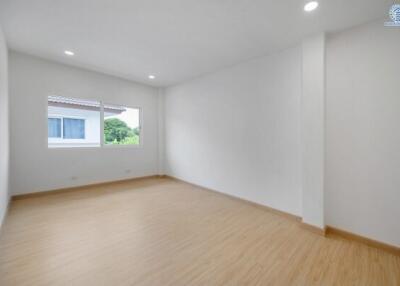 Spacious empty bedroom with large window