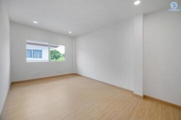 Spacious empty bedroom with large window