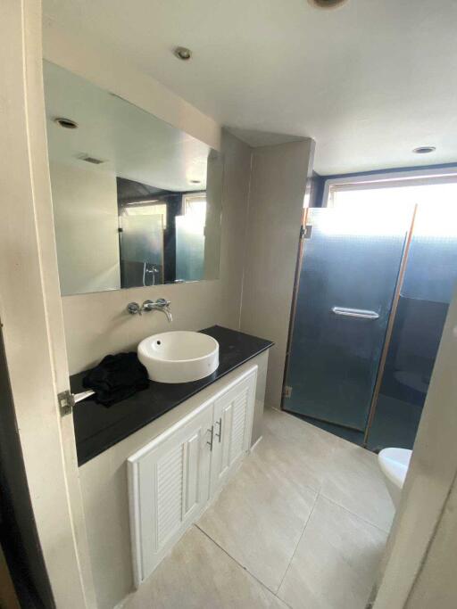 Modern bathroom with sink, mirror, and shower