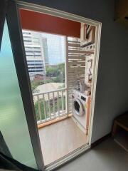Balcony with laundry area and city view