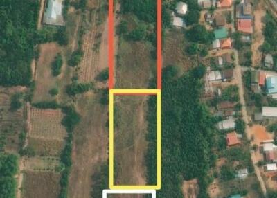 Aerial view of land plots outlined in red, yellow, and white