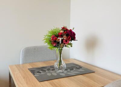 Modern dining area with a decorative bouquet on the table