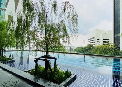 Outdoor area with a swimming pool and city view