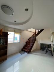 Stairwell in a living space with large window and bookshelf