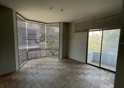 Spacious living room with large windows and balcony access