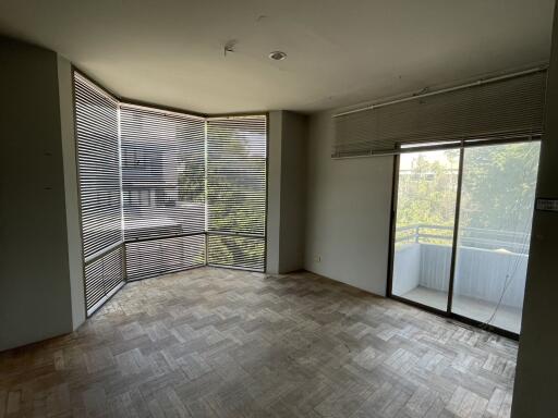 Spacious living room with large windows and balcony access